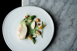Halibut, pancetta, wild garlic, salsify puree, hedgehog mushrooms, halibut bone sauce (Credit: Jenny Jones Photography)